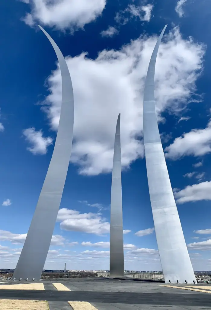 Three curving stainless-steel spires of the U.S. Air Force Memorial against a blue sky