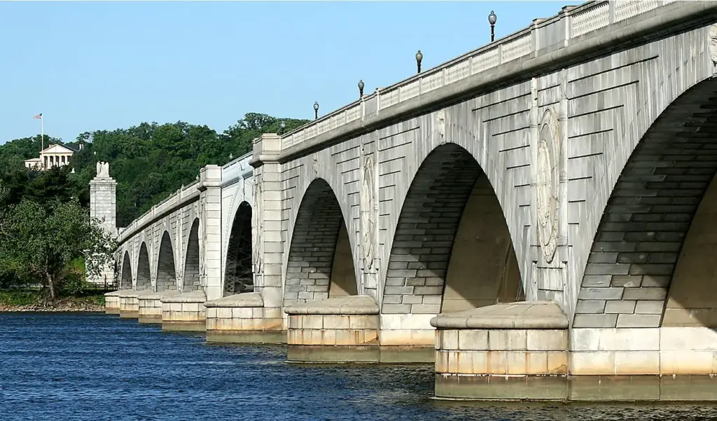 The low granite arches of Arlington Memorial Bridge spanning the Potomac River