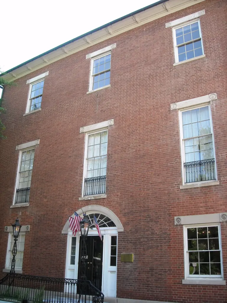 Decatur House's red-brick Federal facade with a fanlight doorway