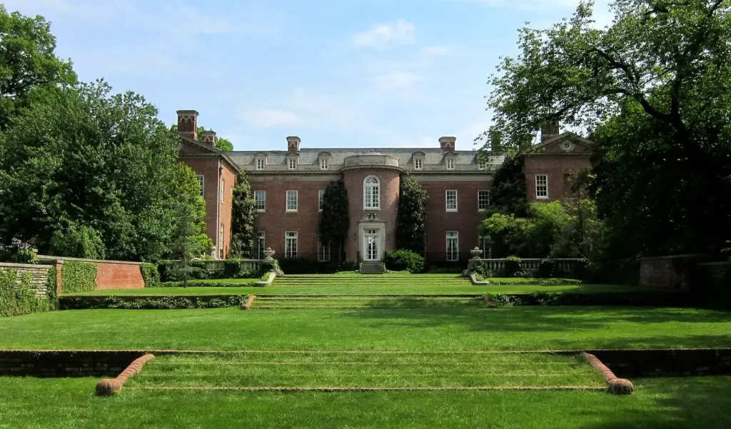 The brick Federal-style mansion at Dumbarton Oaks behind terraced lawns and hedges