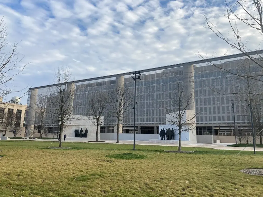 The Dwight D. Eisenhower Memorial's tall woven steel screen and bronze statue groups in a small park off Independence Avenue