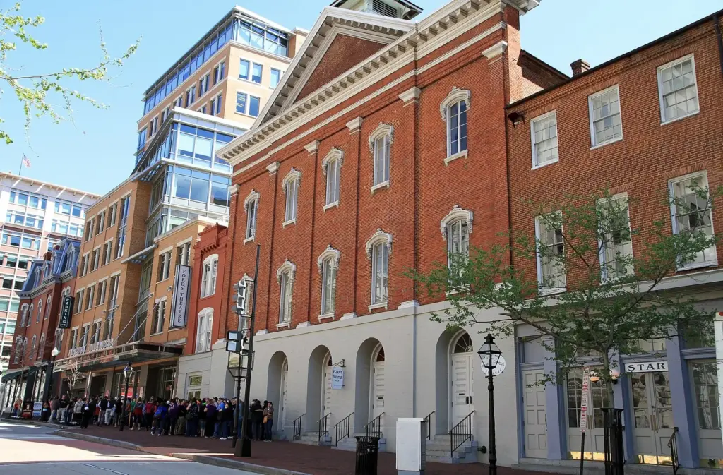 Ford's Theatre's red-brick facade on 10th Street with a line of visitors outside