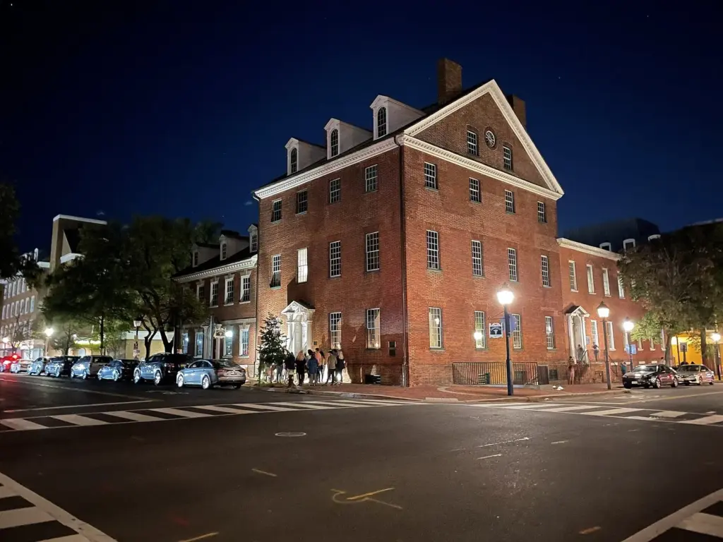 Gadsby's Tavern's brick Georgian buildings lit by streetlights at night