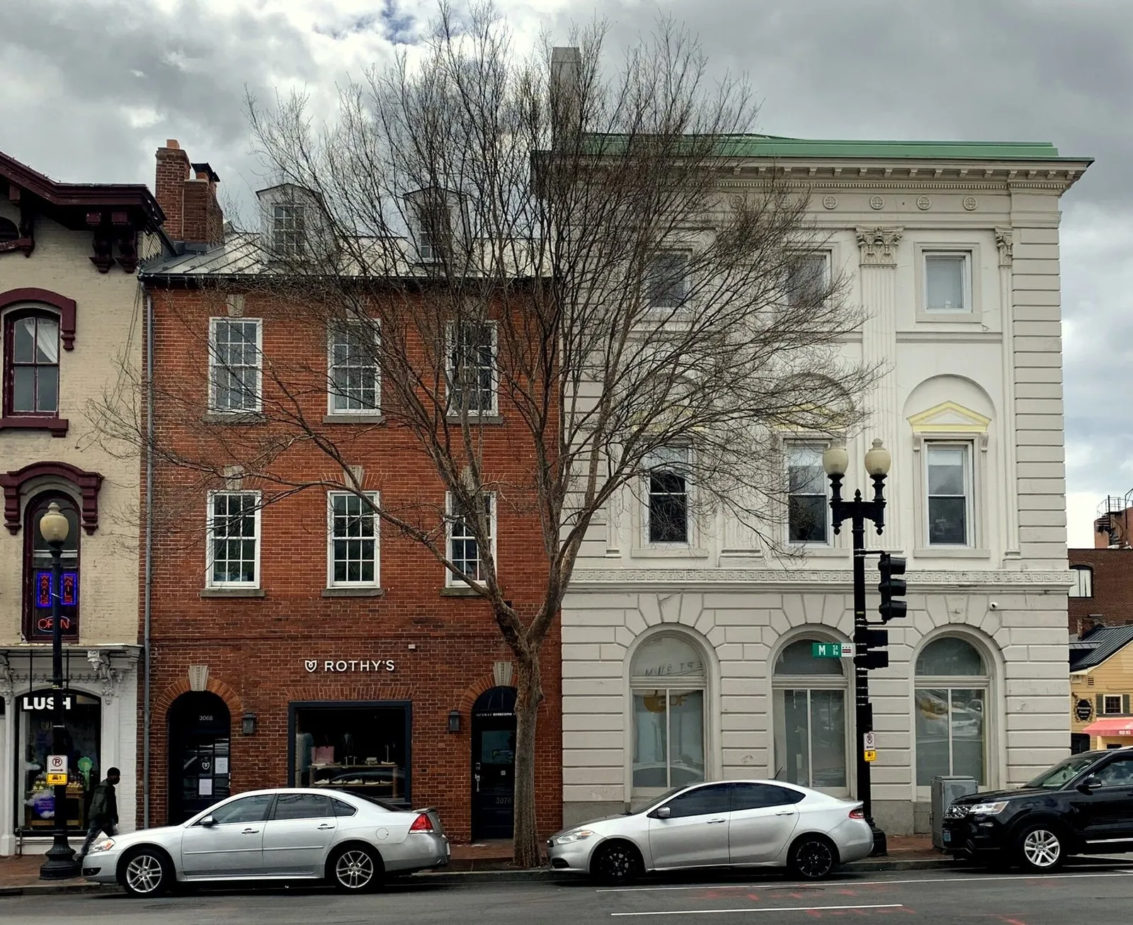 Federal-style brick and white stone shopfronts at M Street and Wisconsin Avenue, the crossroads of shopping in Washington DC