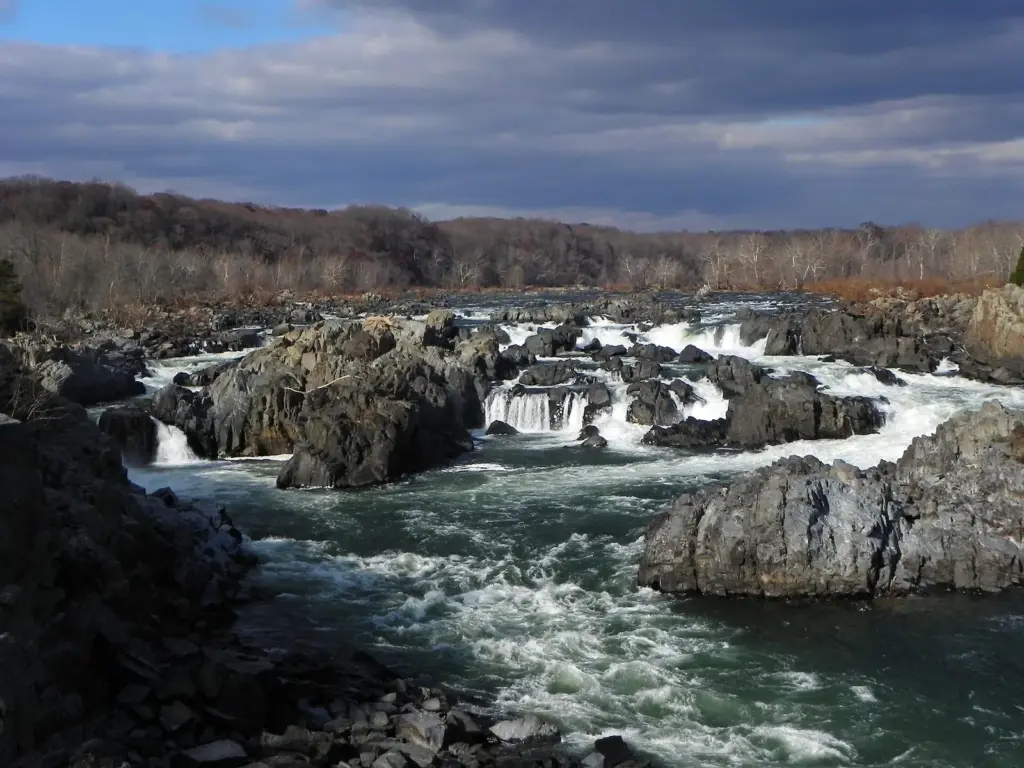 The Potomac River pouring over rocky ledges at Great Falls under a cloudy November sky