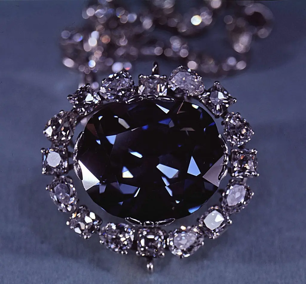 Close-up of the deep blue cushion-shaped diamond surrounded by a ring of white diamonds
