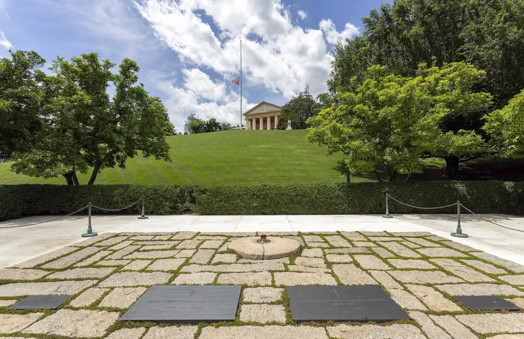 The Kennedy gravesite's stone terrace and eternal flame with Arlington House on the hill above
