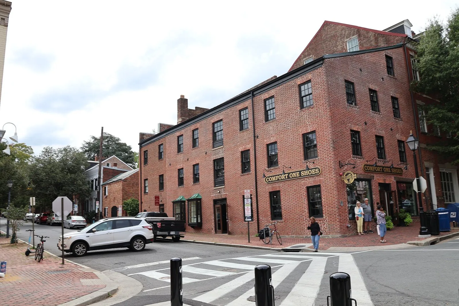 Brick buildings and brick sidewalks at a King Street corner in Old Town Alexandria