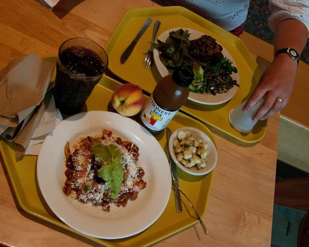 A cafeteria tray with a bean and corn dish, a salad of greens and a drink at the Mitsitam cafe