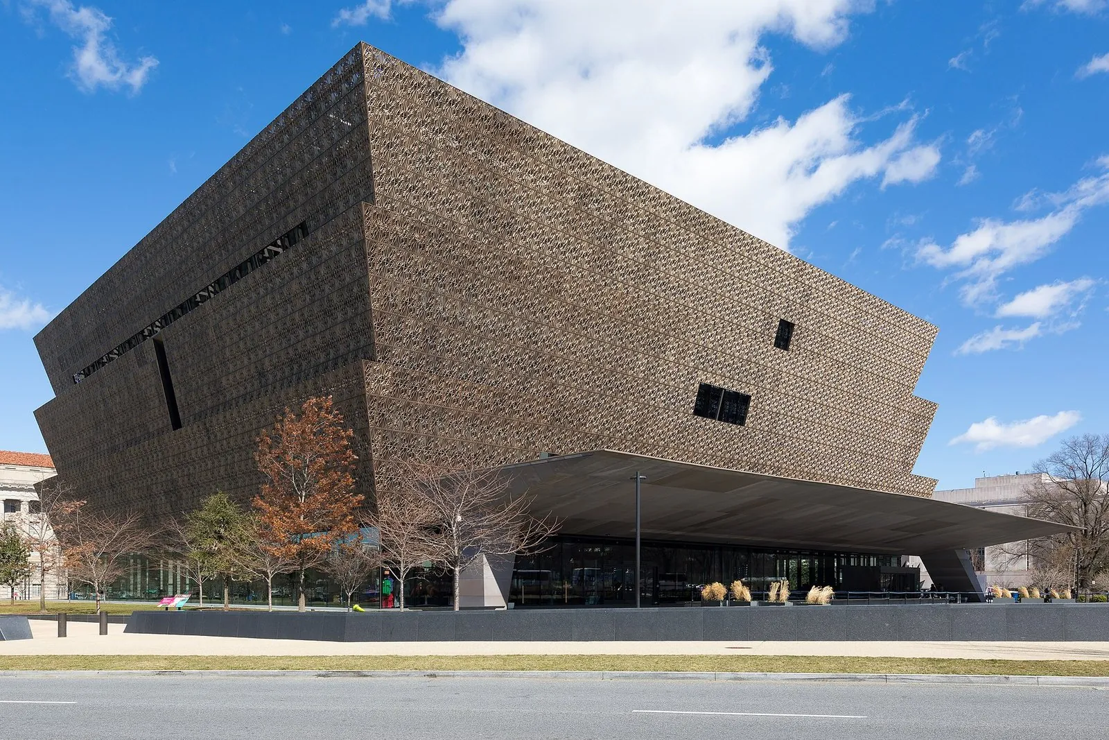 Smithsonian museums on the National Mall: the bronze-latticed National Museum of African American History and Culture under a blue sky