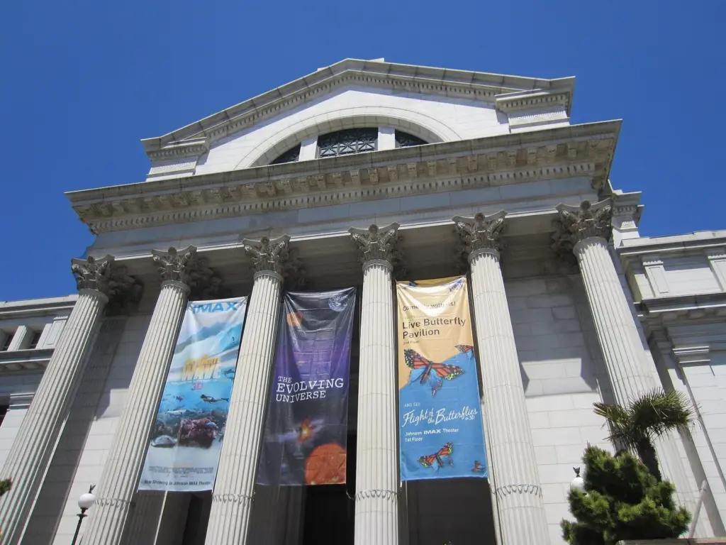 The columned Madison Drive entrance of the natural history museum with exhibition banners hanging between the columns