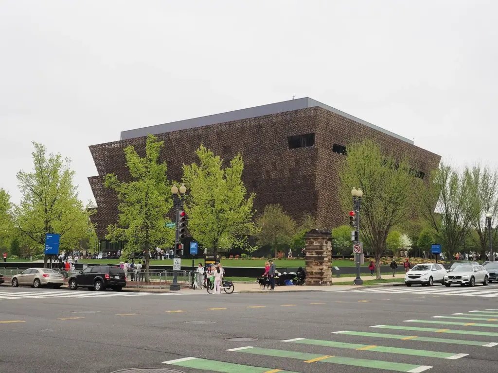 The bronze-colored, tiered facade of the National Museum of African American History and Culture in spring