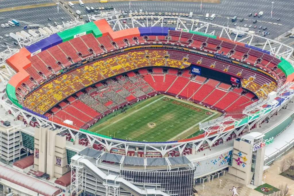 Aerial view of the Commanders' stadium in Landover, Maryland, with its tiered red and yellow seating bowl