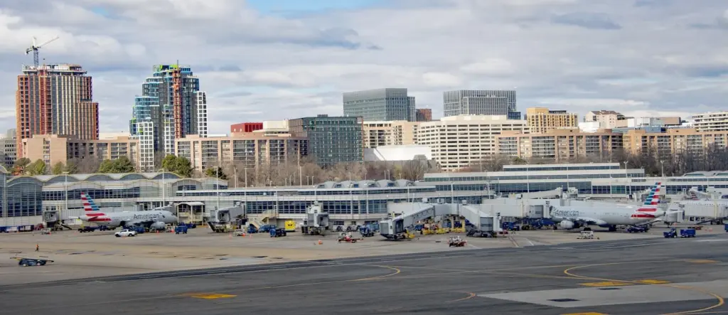 Reagan National Airport's terminal and American Airlines jets at the gates, with the Crystal City towers behind