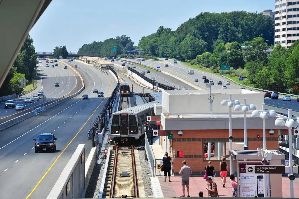 Silver line Metro trains at an elevated station in the median of a Virginia highway
