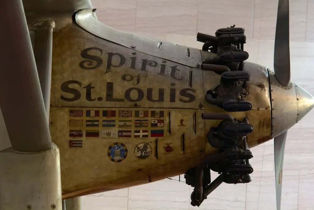 Close-up of the silver nose of the Spirit of St. Louis, painted with its name and rows of small flags