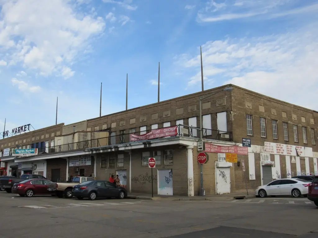 The low brick Union Market building on a sunny day, with parked cars along the street