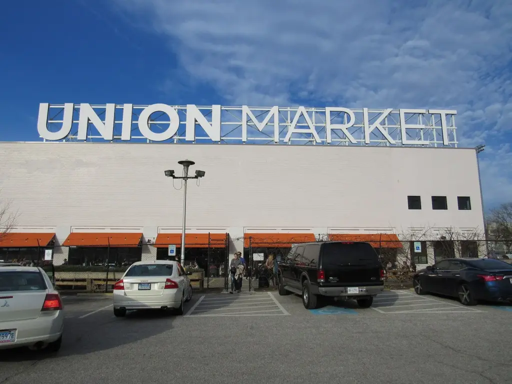 The large Union Market sign on top of a white warehouse-style food hall with orange awnings