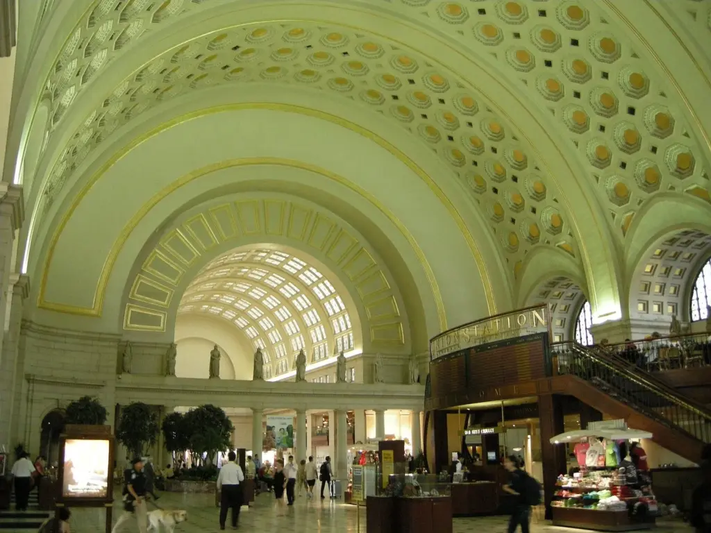 The gilded coffered barrel vault of Washington Union Station's main hall above shops and travelers