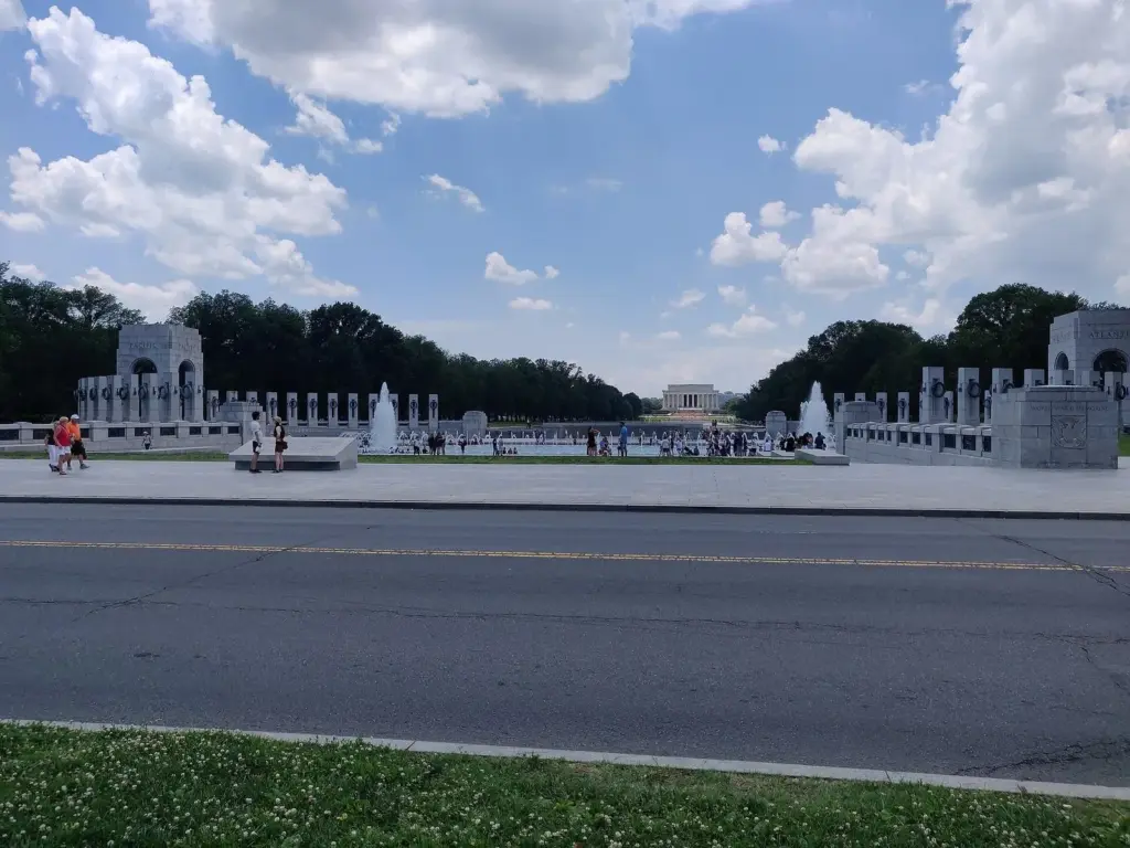 The National World War II Memorial's granite pillars and fountains, with the Lincoln Memorial in the distance