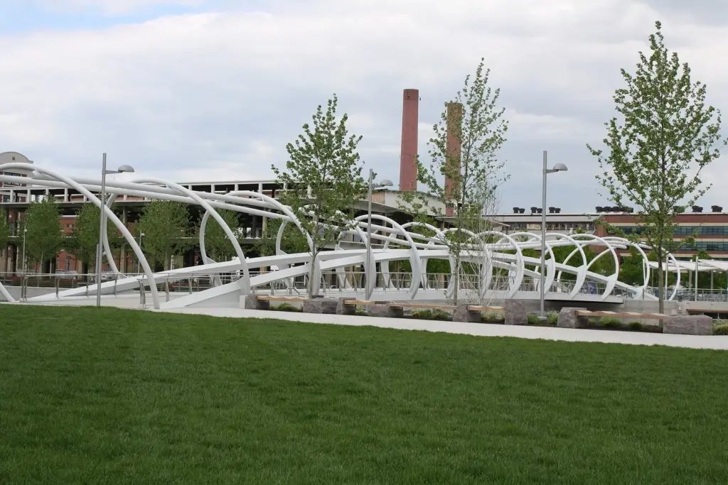 The white arched pedestrian bridge and lawn at Yards Park on the Anacostia River in Navy Yard